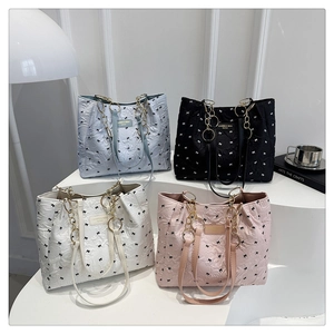 Quilted tote bags with small bows in light blue, black, white, and pink color variants