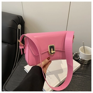 Close-up of pink crossbody bag with two-tone metal lock and leather strap detail