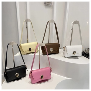 Close-up of five colorful leather crossbody bags featuring a gold U-shaped metal buckle