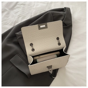 Interior view of white crocodile pattern shoulder bag showing phone storage and chain detail
