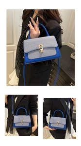Detailed macro view of the striped fabric texture and golden horseshoe metal buckle on bag