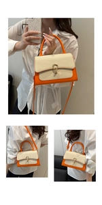 Detail of orange leather and beige canvas crossbody bag with gold metallic lock