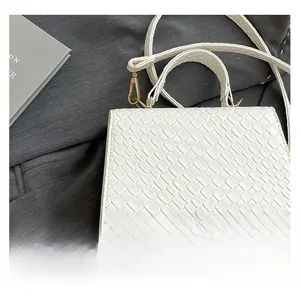 Detailed macro view of white crocodile pattern PU leather with golden metal strap buckles