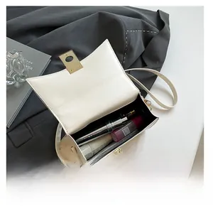 Interior view of white leather crossbody bag showing capacity for phone and cosmetics