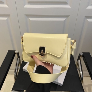 Chic cream leather crossbody bag with gold lock and wide shoulder strap for women