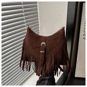 Detail of dark brown suede shoulder bag with long fringes and metal square buckle