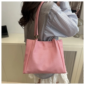 Macro detail of pink woven canvas tote bag with stylish gold ring strap connector