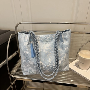 Blue jacquard tote bag with butterfly embroidery, woven handles and silk tassel charm
