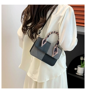 Detail of vintage square crossbody bag with grey textured fabric and silk scarf wrap
