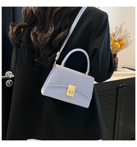 Rear view of model wearing a lavender woven contrast texture mini satchel bag with gold lock