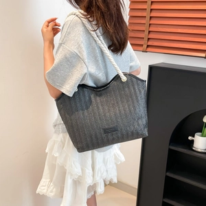 Large capacity woven straw tote bag with rope handles and leather logo patch in dark grey