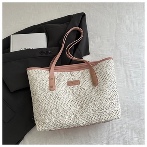 Detailed close-up of white floral lace tote bag with pink faux leather trim and gold studs