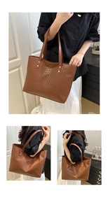 Detail of a brown woven leather tote bag showing texture and shoulder strap on a model