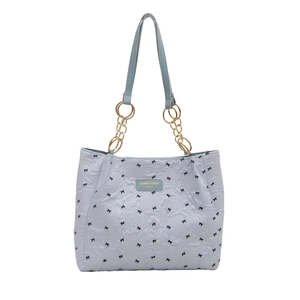 Light blue tote bag with black bow print, pleated texture and gold chain straps