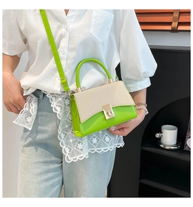 Chic green and beige woven crossbody bag worn by a model in a casual indoor setting