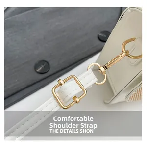 Detail of adjustable white leather strap with golden metal buckle and spring hook clasp