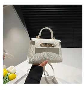 Detail of white woven texture mini Kelly bag with gold twist lock and handle