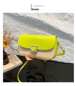 Détail d'un petit sac carré en cuir vert et tissé avec boucle métallique en forme de D