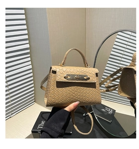 Macro shot of the khaki woven texture and metallic clasp on this elegant handbag