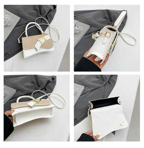 Detail view of two-tone leather square bag with gold hardware and adjustable strap