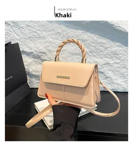 Détail du sac à main en cuir kaki avec poignée nouée tressée et fermoir en métal doré