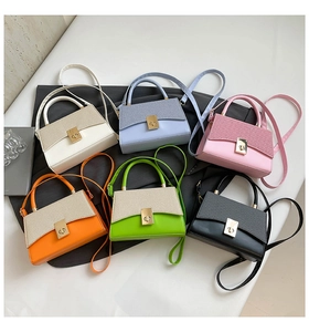 Detail view of six contrast color crossbody bags in cream, blue, pink, and more colors