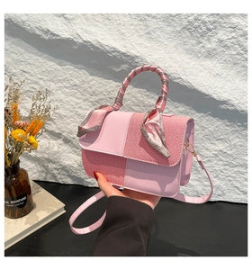 Pink patchwork crossbody bag with textured leather and a silk scarf wrapped handle