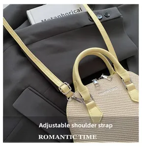 Detail of beige woven handbag with adjustable shoulder strap and fashion branding logo