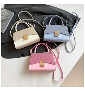 Detailed view of mini crossbody bags with woven textures and gold twist locks