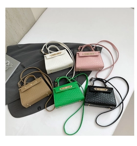 Flat lay of mini textured leather handbags in five colors with metal lock and shoulder straps
