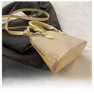 Detail of light yellow patchwork woven handbag with premium textured leather strap