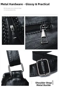 Detail view of black lychee leather bag with metal zipper and adjustable buckle