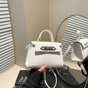 Elegant white crocodile embossed crossbody bag with gold lock and top handle for women