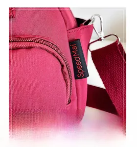 Close-up of burgundy nylon bag with SpeedMai label and silver metal buckle attachment