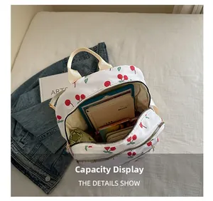 Interior view showing the large capacity of a white nylon backpack with cherry print