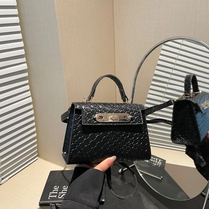 Mini black woven texture Kelly handbag with silver turn-lock and crossbody strap