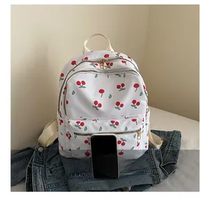 Detailed view of butterfly print backpack with a smartphone to show compact dimensions