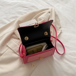 Rose red textured leather handbag with structured flap and golden twist lock closure