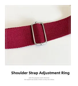 Detail of adjustable wine red nylon shoulder strap with a silver metal buckle slider