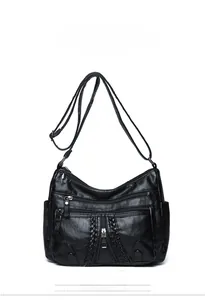 Detailed front view of black PU leather crossbody bag featuring multi-layer zippers