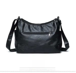Detail view of the black leather shoulder bag back side with a zipper pocket