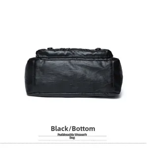 Detailed bottom view of black soft leather shoulder bag with smooth texture and stitching