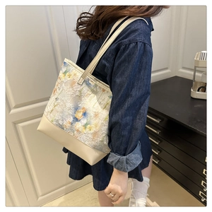 Detailed shot of floral fabric and cream leather stitching on the aesthetic tote bag