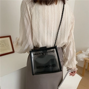 Detailed shot of transparent PVC crossbody bag with black chain strap and inner pouch