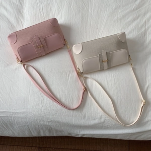 Top view of woven fabric and leather small flap bags with gold hardware and straps