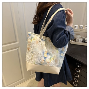 Detail of floral chiffon canvas tote bag featuring embroidered textures and leather splicing