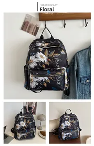 Floral backpack with multiple zipper compartments and side pockets on a clothes rack