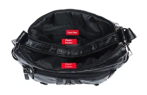 Detail view of the black leather shoulder bag with multiple zippered inner compartments