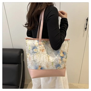 Detail of floral chiffon canvas tote bag featuring pink leather base and 3D flower embroidery