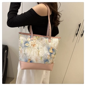 Floral chiffon tote bag with pink leather trim shown worn by a model on shoulder
